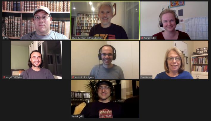 The smiling faces of a zoom capture of the nine people that attended HWC West.