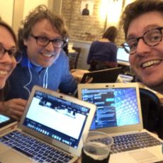 tiaramiller.com, mfgriffin.com, and martymcgui.re smile at the camera, each leaning their laptops crowded close together on a small coffeeshop table.