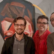 From left to right: gRegor Morrill, Jordan Yonts, Joe Crawford, and Simon Prickett standing in front of a painting of David Bowie